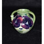 A MOORCROFT TWIN HANDLED 'PANSY' PATTERNED VASE impressed marks and painted signature to base, 8.5cm