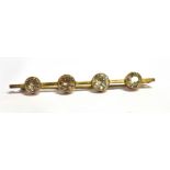 A ZIRCON FOUR STONE 9CT GOLD BAR BROOCH white and light brown round mixed cut zircon approx. 7mm
