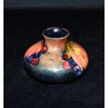 A MOORCROFT POTTERY 'LEAF AND BERRY' PATTERN VASE of squat ovoid form, 7.5cm high, impressed W