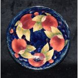 A MOORCRFT POTTERY 'POMEGRANATE' PATTERN DISH 18.5cm diameter, painted and impressed marks to