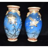 A LARGE PAIR OF JAPANESE VASES decorated with birds and blossoming branches, 34cm high Condition