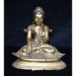 A BRONZE FIGURE OF A SEATED BUDDHA with glass inset eyes and decoration to headdress, 25cm high