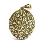 A LARGE UNMARKED WHITE METAL LOCKET The locket with embossed pattern to the back of flowers and