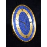 A JAEGER LE COULTRE EASEL BACK 8-DAY MANTLE CLOCK with gilt brass case and faux lapis lazuli dial,