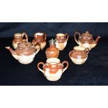 A COLLECTION OF DOULTON LAMBETH AND OTHER MINATURE SALTGLAZE STONEWARE ITEMS comprising two teapots,