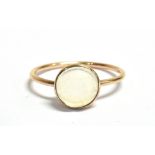 A YELLOW GOLD 'MOONSTONE SET' DRESS RING the single cabochon cut glass moonstone approx. 8mm