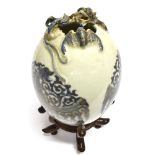 A CHINESE PORCELAIN VASE OF OVOID FORM relief decorated around the rim with a dragon and bat, the