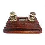 A LATE 19TH OR EARLY 20TH CENTURY OAK DESK STAND fitted with two glass inkwells and a small glass