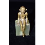AN ART DECO BRONZE FIGURE of a nude female, seated on square onyx base, 9.5cm high overall Condition