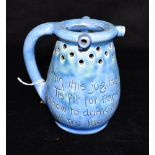A BARON BARNSTAPLE PUZZLE JUG inscribed with the verse 'Within this jug there is good liquor, Tis