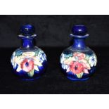 A PAIR OF MOORCROFT POTTERY 'ORCHID' PATTERN SCENT BOTTLES impressed signatures, 'POTTER TO HM THE