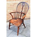A FRUITWOOD WINDSOR ARMCHAIR with pierced and carved splat, on crinoline stretcher base