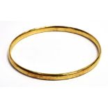 A 9CT GOLD BANGLE the slip over bangle (no clasp) with faded 375 hallmark, bangle width 0.5cm,