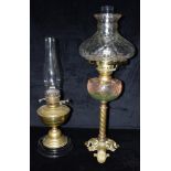 A VICTORIAN OIL LAMP WITH CLEAR GLASS SHADE AND RESERVOIR 66cm high, and another (2)