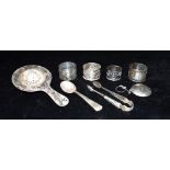 A CHINESE EXPORT WHITE METAL TEA STRAINER Marked Tuckchang together with four Chinese napkins rings,