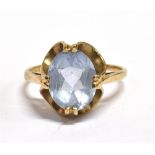 A 9CT GOLD AQUAMARINE COCKTAIL RING the facetted oval aquamarine measuring 0.9 x 0.7cm, shank with