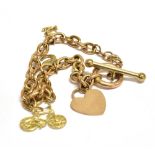 A TAGGED 9CT CHAIN BRACELET with four attached charms, the bracelet with toggle clasp, one charm