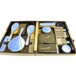 AN ART DECO SILVER AND ENAMEL SIXTEEN PIECE CASED VANITY/DRESSING TABLE SET the set in blue sun