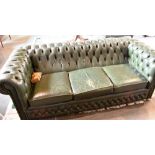 A THREE SEATER GREEN LEATHER BUTTON UPHOLSTERED CHESTERFIELD SOFA