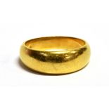 AN 18CT GOLD WIDE BAND RING the shank with worn hallmark, band width 0.5cm, size V, weight 12.