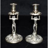 A MATCHED PAIR OF EDWARDIAN SILVER CANDLESTICKS the small candlesticks designed as figural