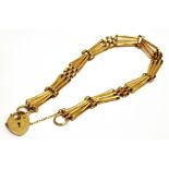 A 9CT GOLD HEART PADLOCK OPEN LINK BRACELET and safety chain the padlock and bracelet with faded