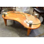 AN ART DECO STYLE TWO TIER OCCASIONAL TABLE with shaped plate glass top above veneered undertier, on