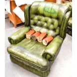 A GREEN LEATHER UPHOLSTERED ARMCHAIR