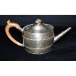 A GEORGE III SILVER TEAPOT the teapot of barrel shape with brown ebonised handle and knob,