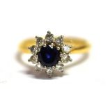 A SAPPHIRE AND DIAMOND FLOWER HEAD RING Sapphire measurement 0.5cm shank marked 18ct PLAT Ring