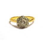 A DIAMOND SET FLOWER HEAD RING Shank with faded 18 or 15ct marking, ring size O, weight 3.2g