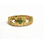 A 9C GOLD EMERALD SET DRESS RING the ring set with a tiny emerald with openwork heart detail, ring