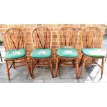A SET OF FOUR OAK WHEELBACK DINING CHAIRS