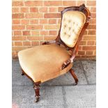 A VICTORIAN CARVED WALNUT FRAMED NURSING CHAIR on turned and fluted supports