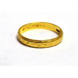 AN 18CT GOLD ENGRAVED PATTERN BAND RING The ring with faded hallmark, band width 0.4cm, ring size S,