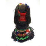 A SOUTH AFRICAN NDEBELE OR ZULU SANGOMA DOLL with traditional beadwork decoration, 16cm high.