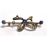 AN EARLY MID 20TH CENTURY SAPPHIRE SET BOW BROOCH The brooch set with three blue Sapphires and