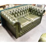 A TWO SEATER GREEN LEATHER BUTTON UPHOLSTERED CHESTERFIELD SOFA