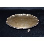 A SILVER CARD TRAY The tray with pie crust border and with three roll back feet, Silver Jubilee