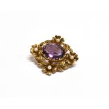 A 9CT GOLD, AMETHYST AND SEED PEARL BROOCH the faceted oval amethyst measuring 1.7 x 1.4cm and