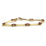 A RUBY SET YELLOW METAL BRACELET Clasp with worn markings, length 17.5cm, weight 9.2g approx.