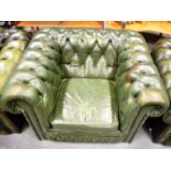 A PAIR OF GREEN LEATHER BUTTON UPHOLSTERED CLUB ARMCHAIRS