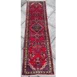 A RED GROUND SAROUK RUNNER 290cm x 80cm Condition Report : good condition, thick pile Condition