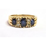 A SAPPHIRE AND OLD CUT DIAMOND DRESS RING the ring set with three faceted oval cut inky blue