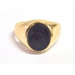 A 9CT GOLD BLUE GOLDSTONE SIGNET RING The oval goldstone measuring 1.2cm X 1cm on a tapered yellow