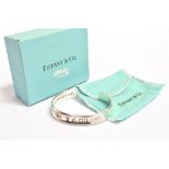 TIFFANY & CO. A SILVER TIFFANY & CO CUFF BANGLE the outside stamped 925 T & Co 1837, the inside ©