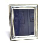 A SILVER FRONTED PICTURE FRAME the frame of plain form with beaded border, hallmarked for