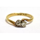 AN 18CT PLATINUM AND DIAMOND TWO STONE CROSSOVER RING Shank marked 18Ct PLAT, ring size M, weight