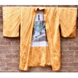 A JAPANESE KIMONO 20th century, of floral patterned golden yellow silk, the cream lining with a