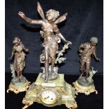 AN EDWARDIAN THREE PIECE FIGURAL SPELTER CLOCK GARNITURE the central clock with winged fairy 'Fee